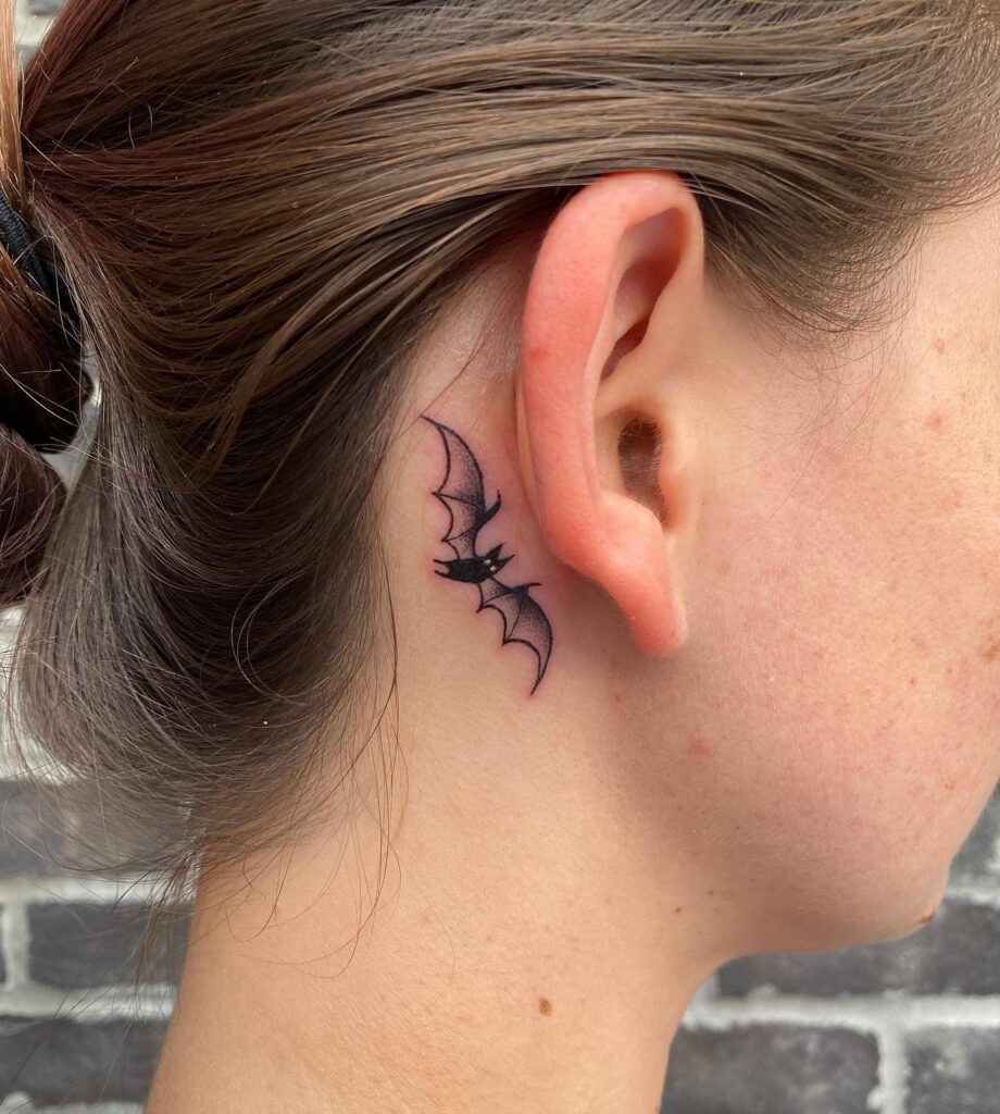 Bats enigmatic charm striking black ink bat tattoo behind the ear