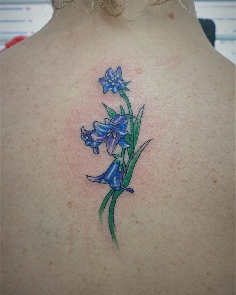 Beautiful Bluebell Flower Tattoo Below the Back of the Neck: Neckline Bloom