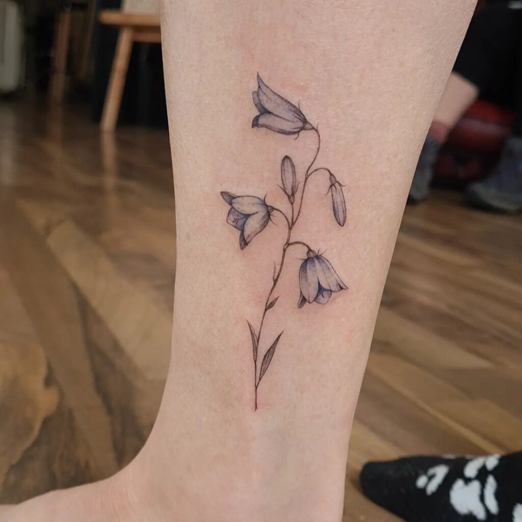 Beautiful bluebell tattoo above the ankle for women natural charm