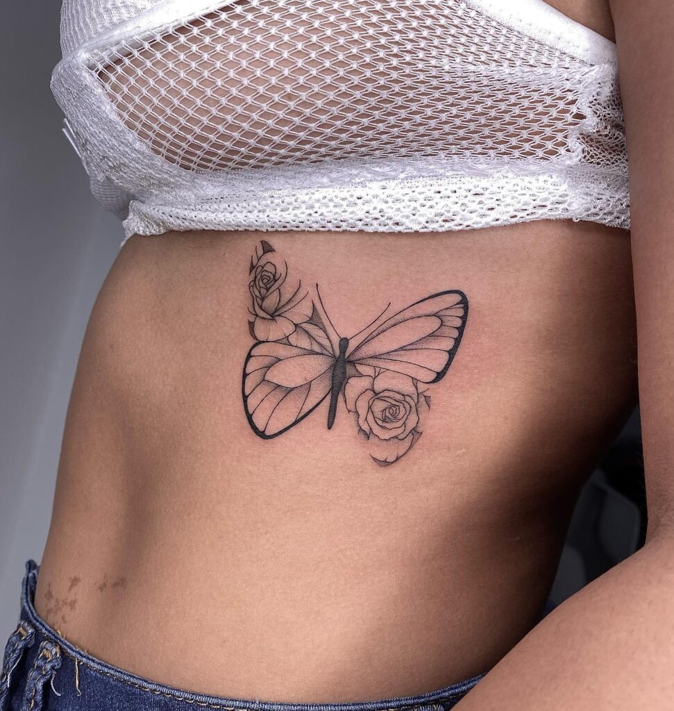Beautiful butterfly with rose fineline detailed tattoo top left and bottom right corners