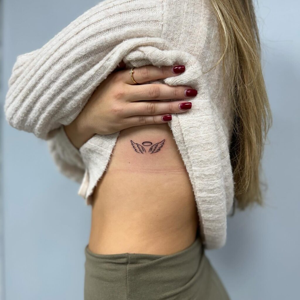 Beautiful Fineline Wings Tattoo on the Rib for Women: Ribbons of Flight