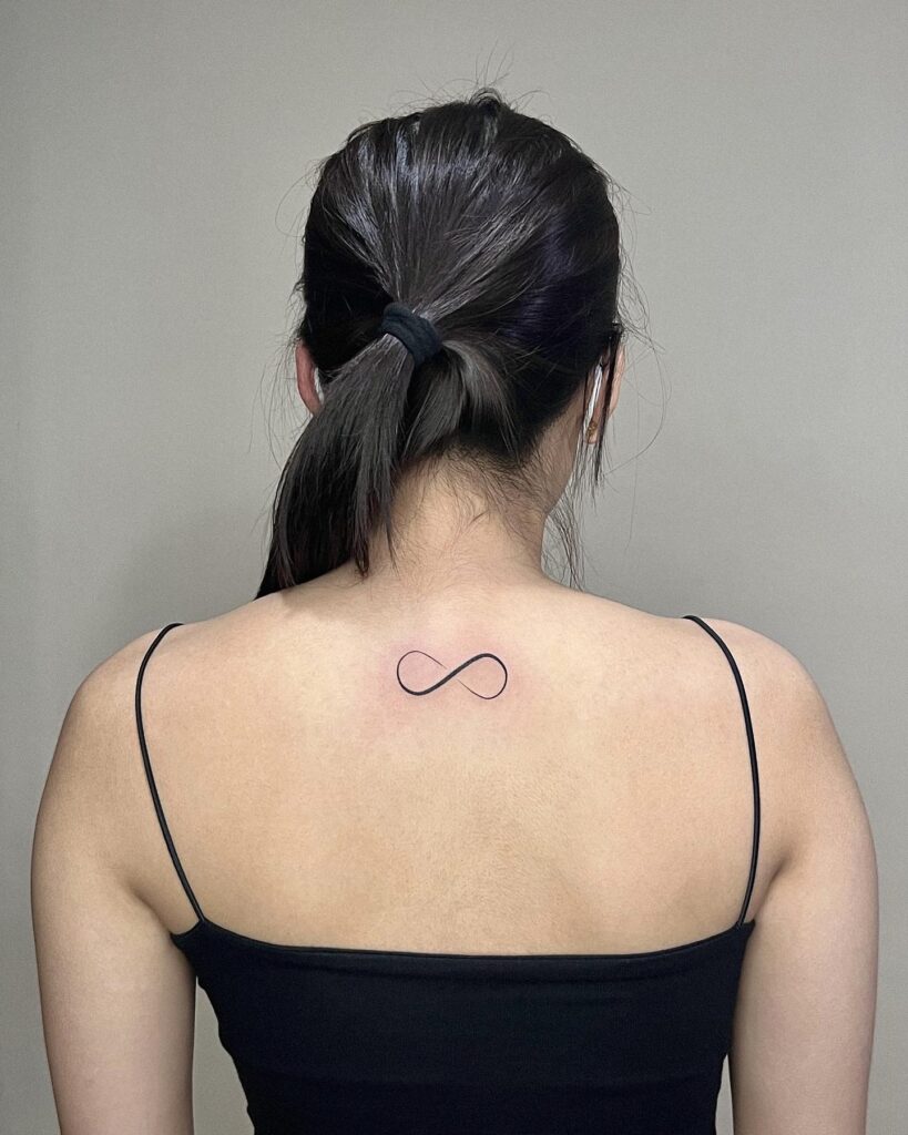 Beautiful infinity symbol tattoo on the back of the neck limitless love