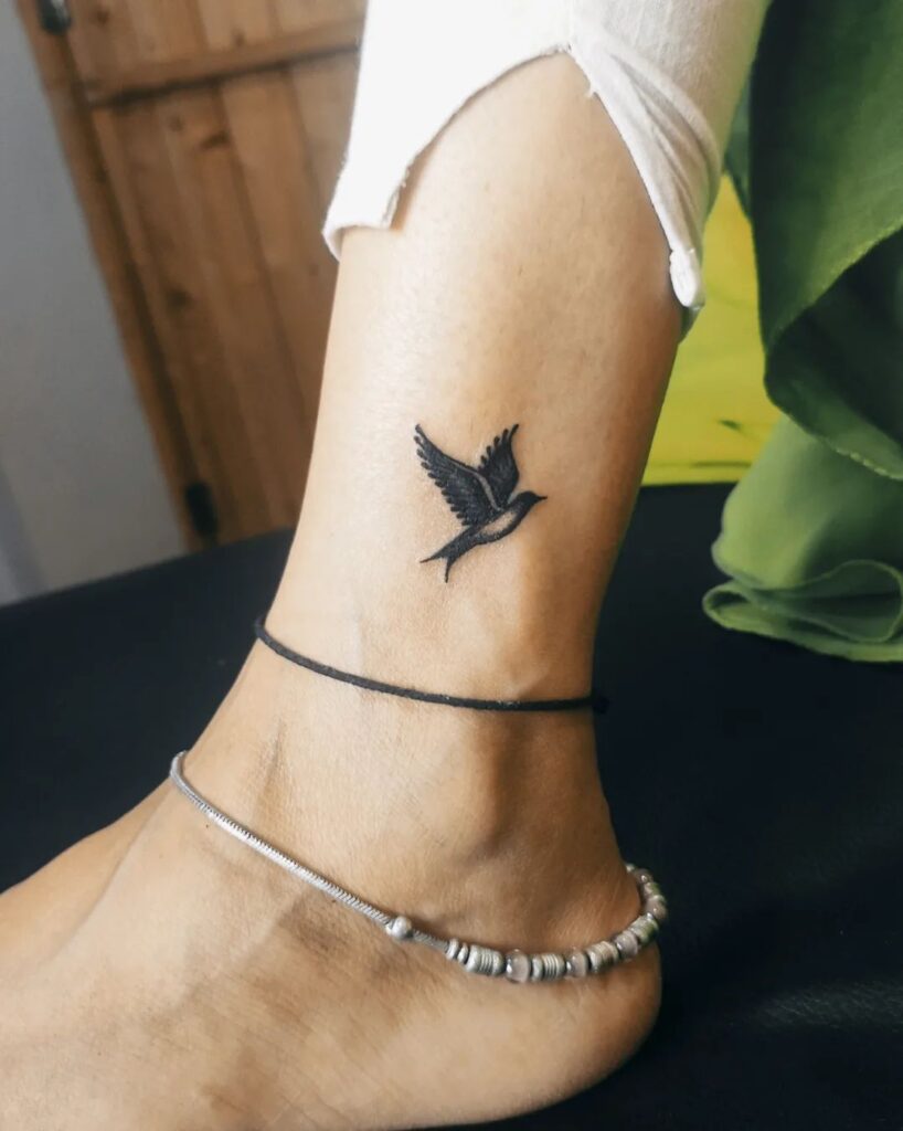 Beautiful mini bird tattoo on ankle for women with image