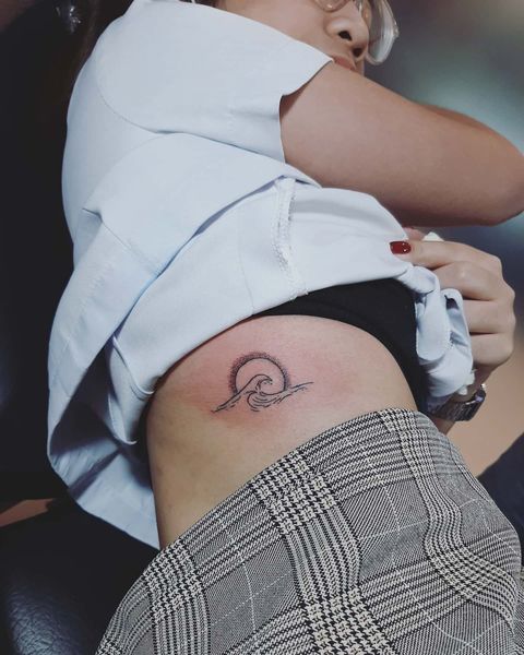 Beautiful Sun and Wave Tattoo Design on the Waist