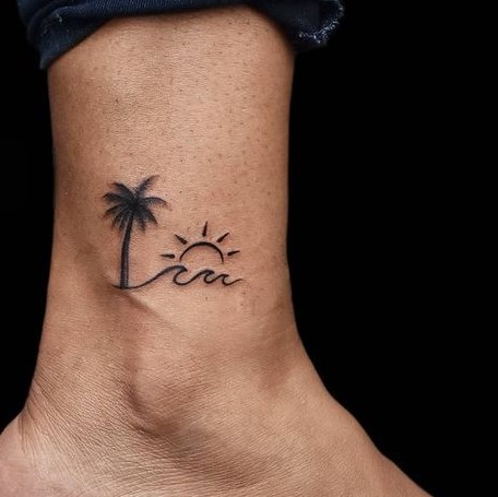 Beautiful Wave and Sun Tattoo on Foot With a Beautiful Palm Tree