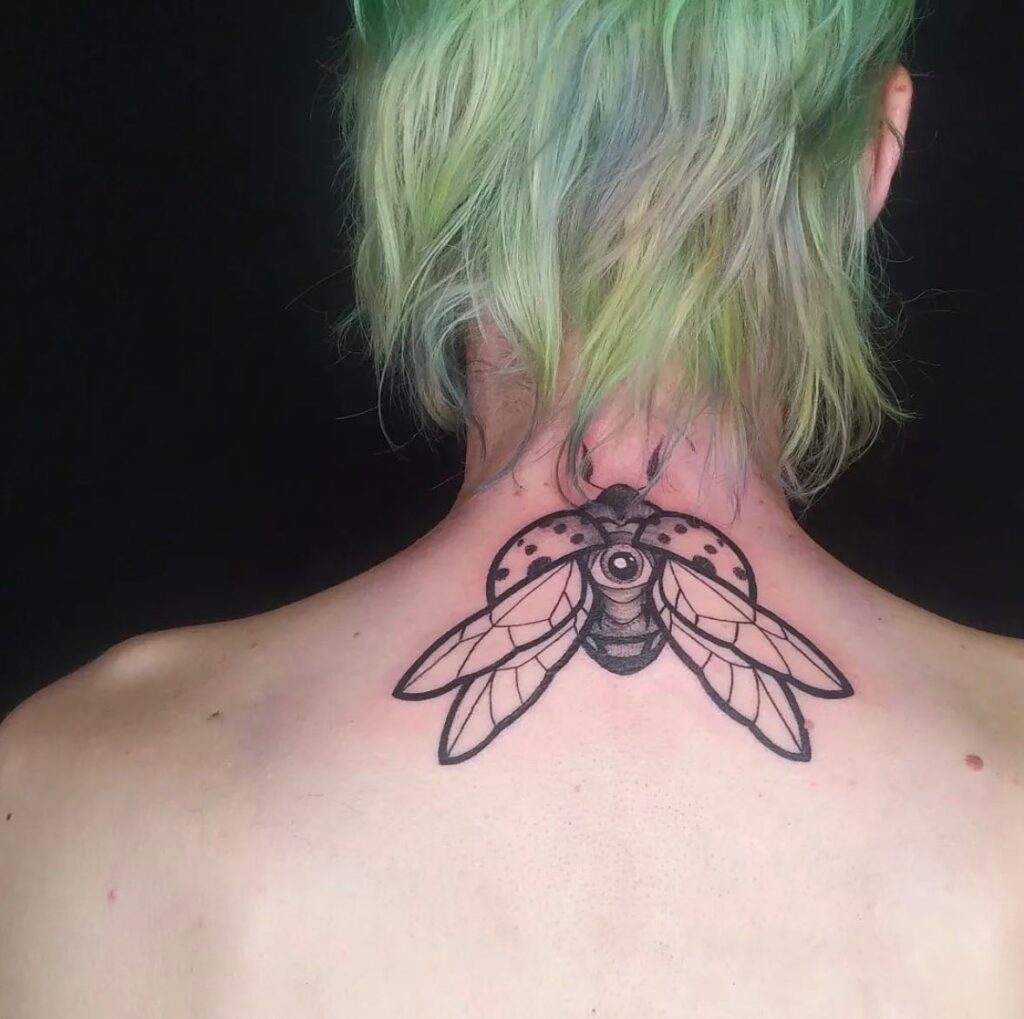 Big Black Outline Ladybug Tattoo on the Back of the Neck Embrace your Uniqueness
