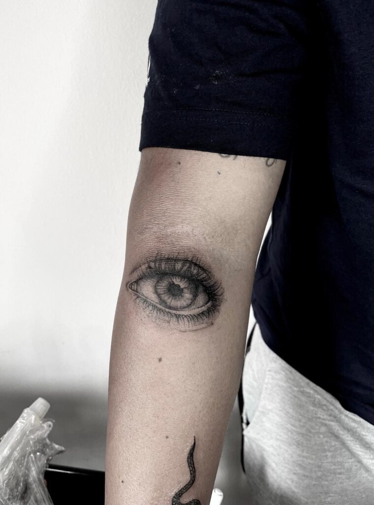Big Black and Grey Eye Tattoo Making a Bold Mark on the Inner Elbow: Intricate Insight