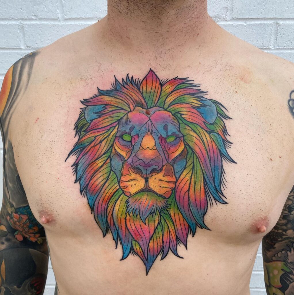 Big lion face tattoo in color on the chest for men: colorful regality