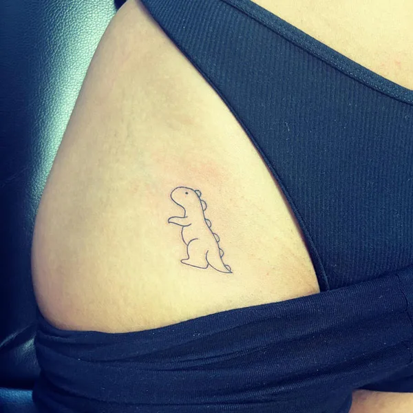 Bikini line dinosaur tattoo