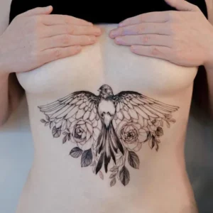 Bird under breast tattoo 1