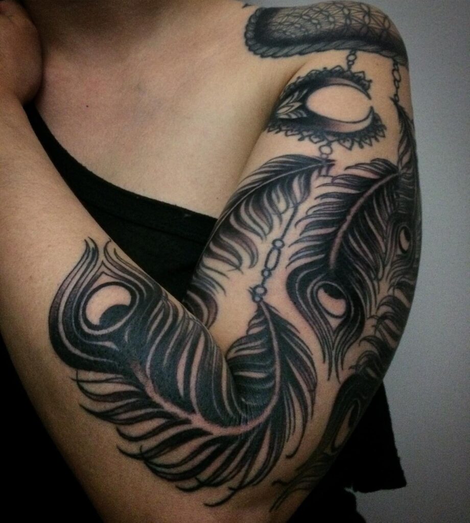 Black Color Full Arm Peacock Feather Tattoo Design Bold and Striking