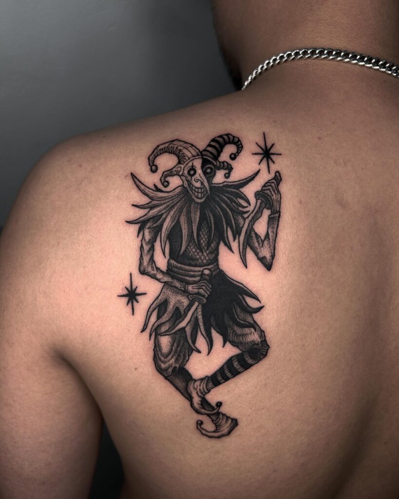 Black Joker Holding Knife Tattoo on the Back of the Shoulder
