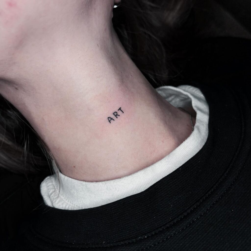 Black and Grey 'ART' Front Neck Tattoo: Artistic Expression