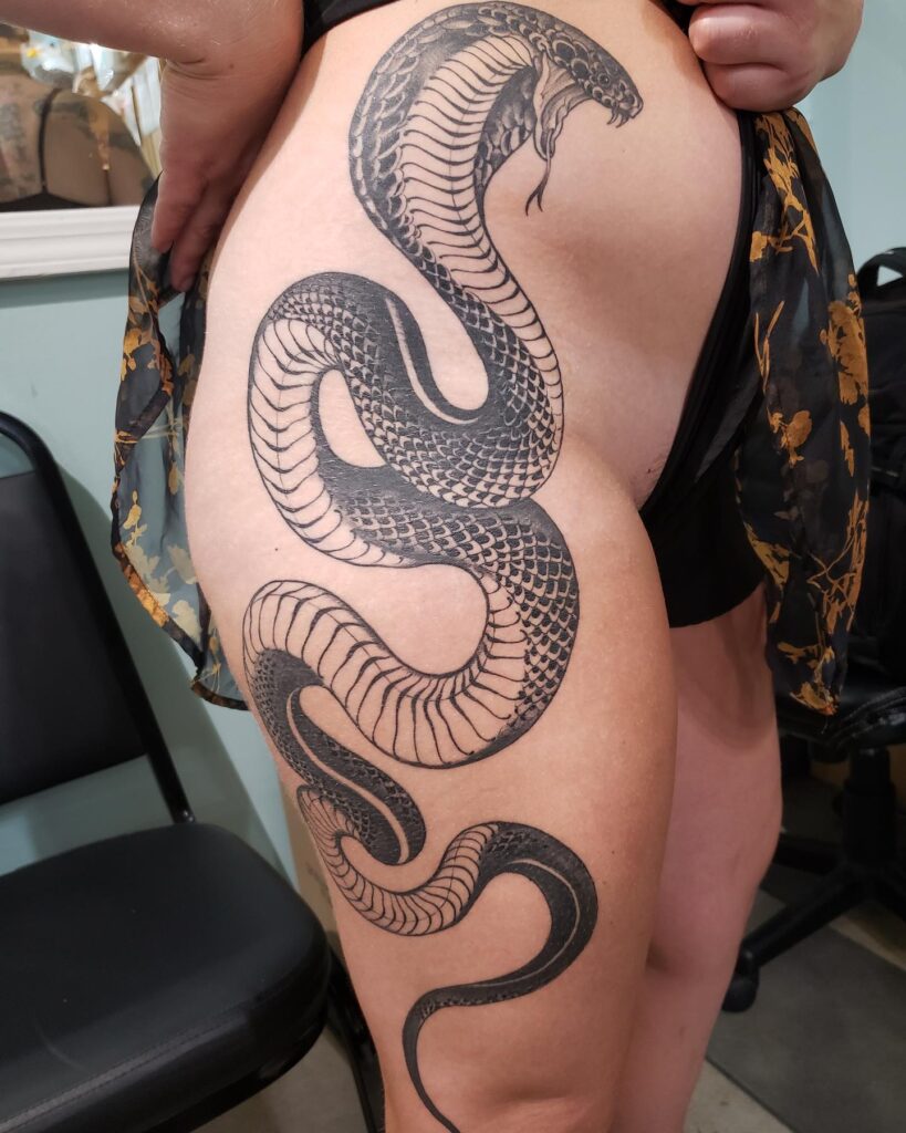 Black and grey cobra tattoo on the side hip for females: sensual serpent