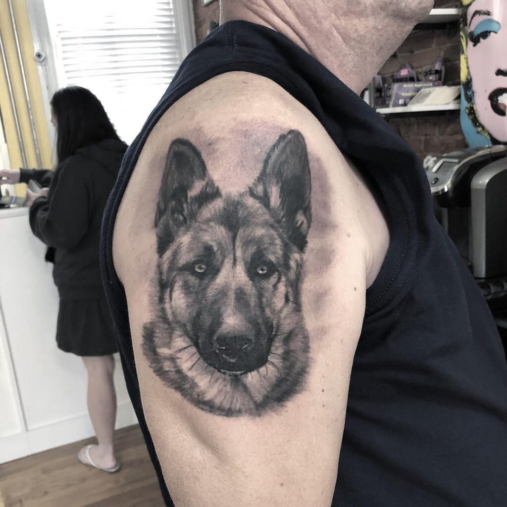 Black and Grey German Shepherd Portrait Tattoo on the Upper Arm: Shaded Devotion