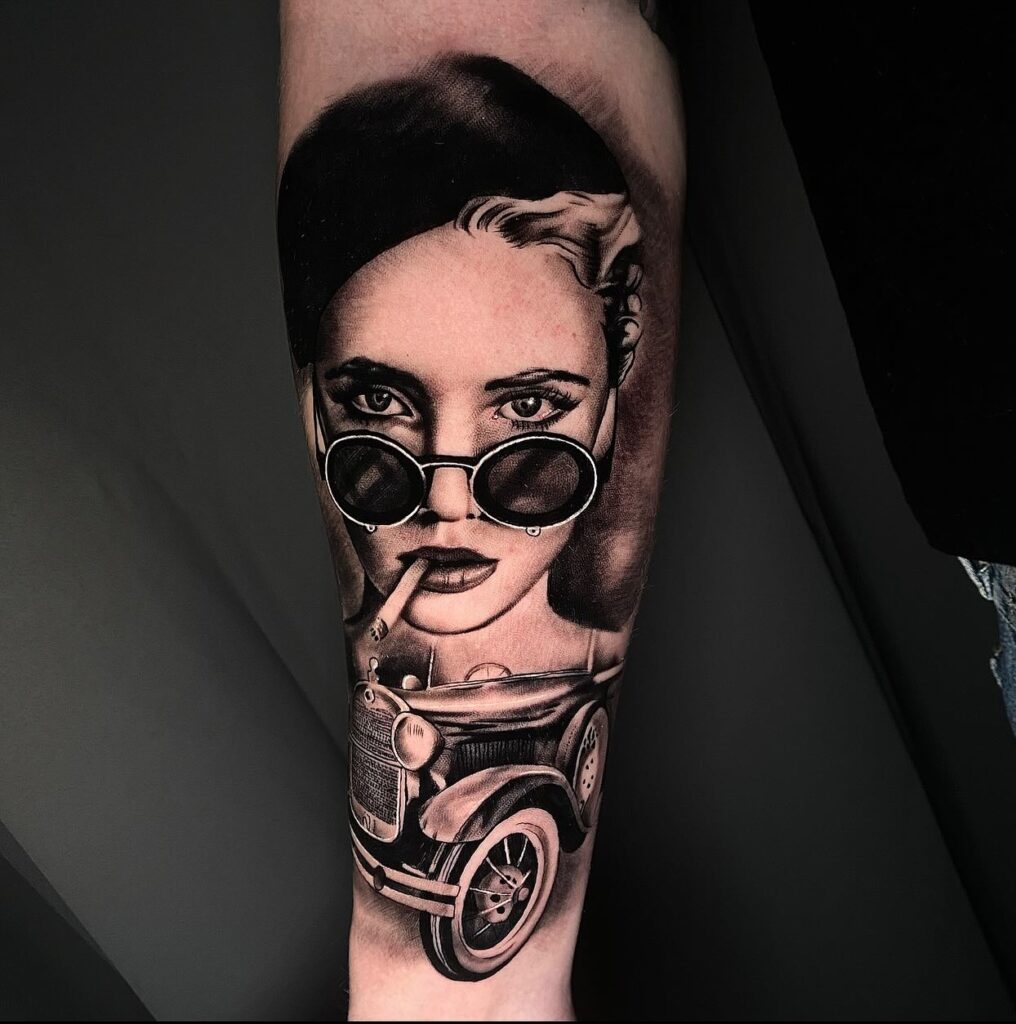 Black-and-Grey Realism Tattoo of a Woman with Round Sunglasses and a Vintage Car on Upper Sleeve – Car Tattoo Ideas