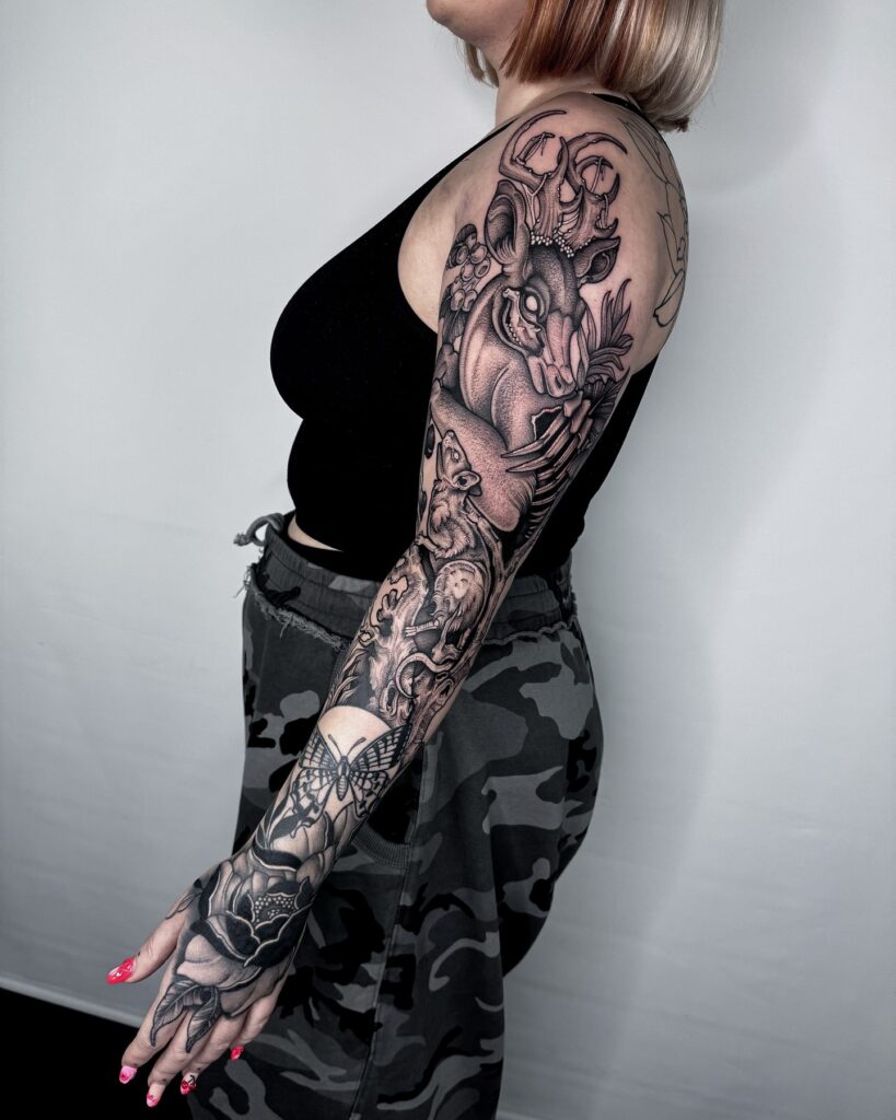 Black and grey wildlife tattoo sleeve featuring stag, owl, and full moon