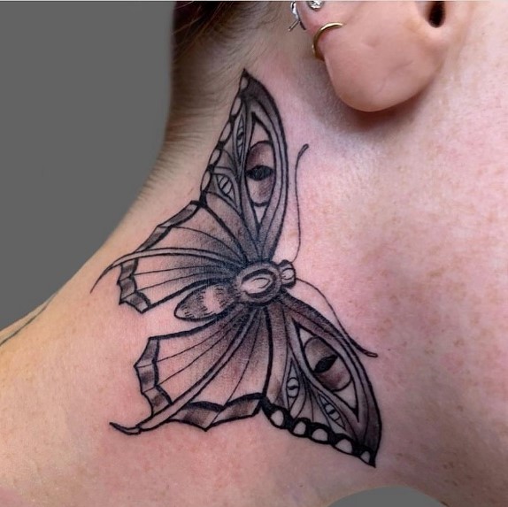 Black Butterfly Tattoo with Eyes Drawn on its Wings
