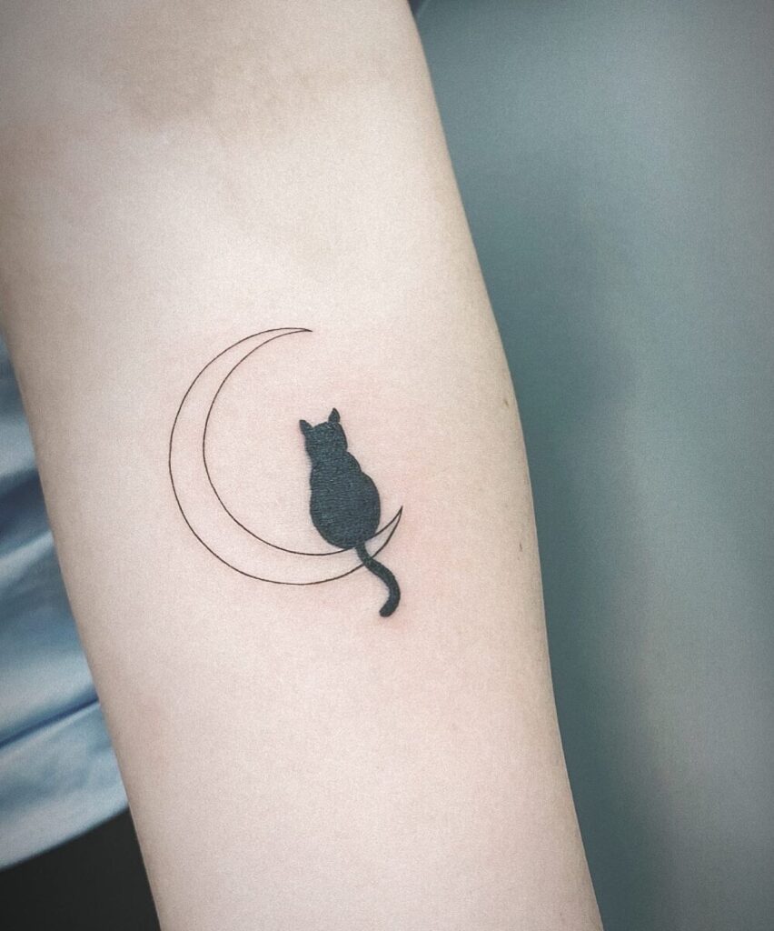 Black Cat Sitting on the Moon Tattoo on the Forearm: Mystical Cat Crescent