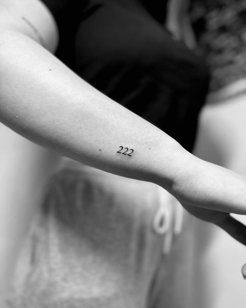 Black Fineline 222 Tattoo on the Side of the Forearm, a Quiet Reminder: Subtle Strength 