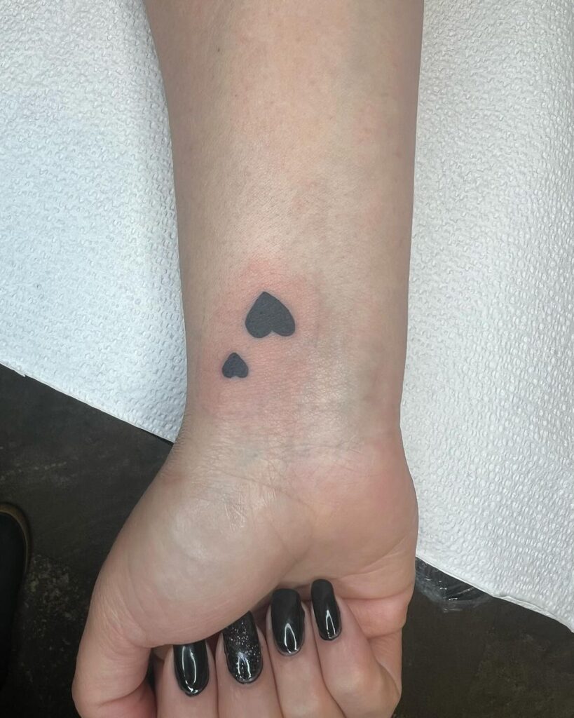 Black heart duo wrist tattoo small and large hearts for unique and personalized design