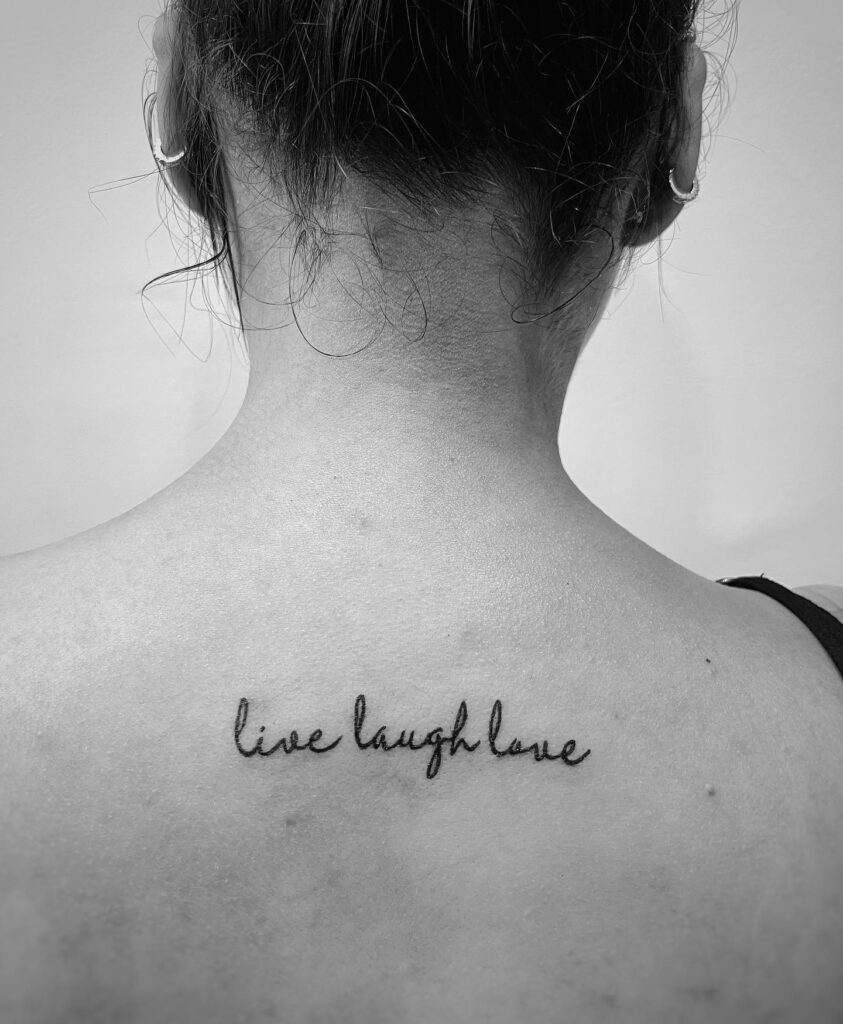 Black Ink Live Laugh Love Tattoo on the Back of the Neck: Nape Wisdom