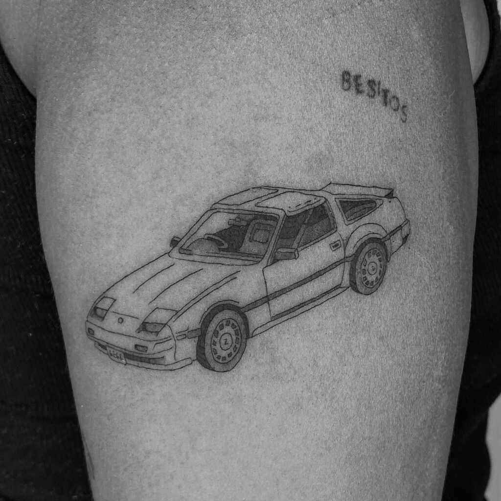 Black Outline Nissan 300ZX Tattoo on Upper Arm with "BESITOS" Inscribed Above – Car Tattoo Ideas