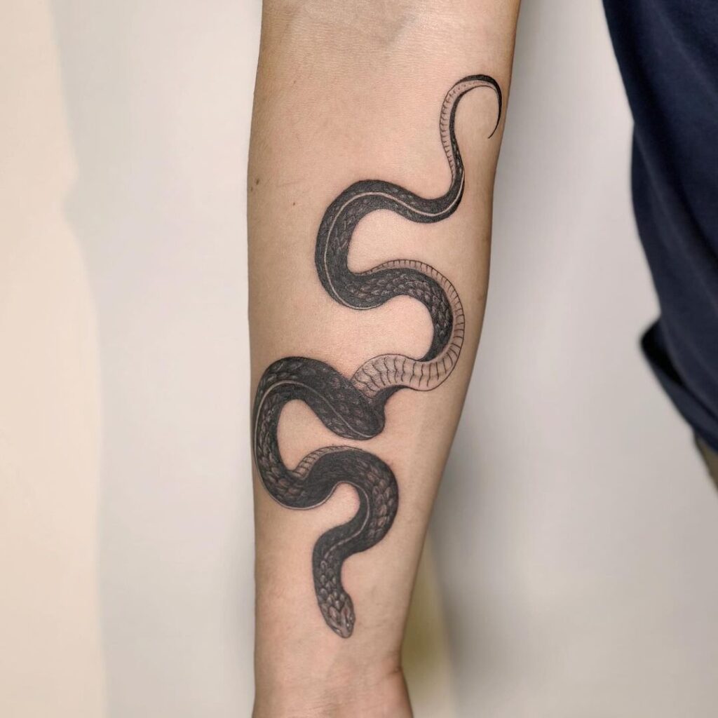 Black scale snake tattoo on the forearm serpentine elegance for men
