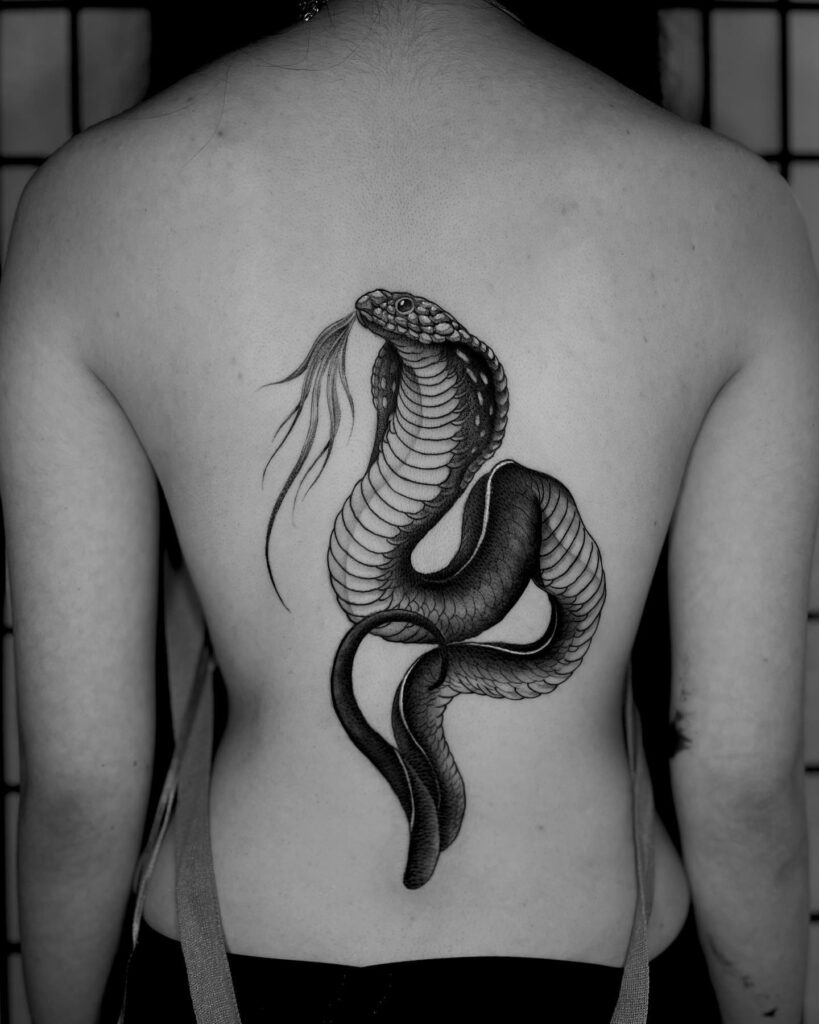 Black Work Cobra Tattoo on the Back with a Graceful Tongue: Mystic Elegance