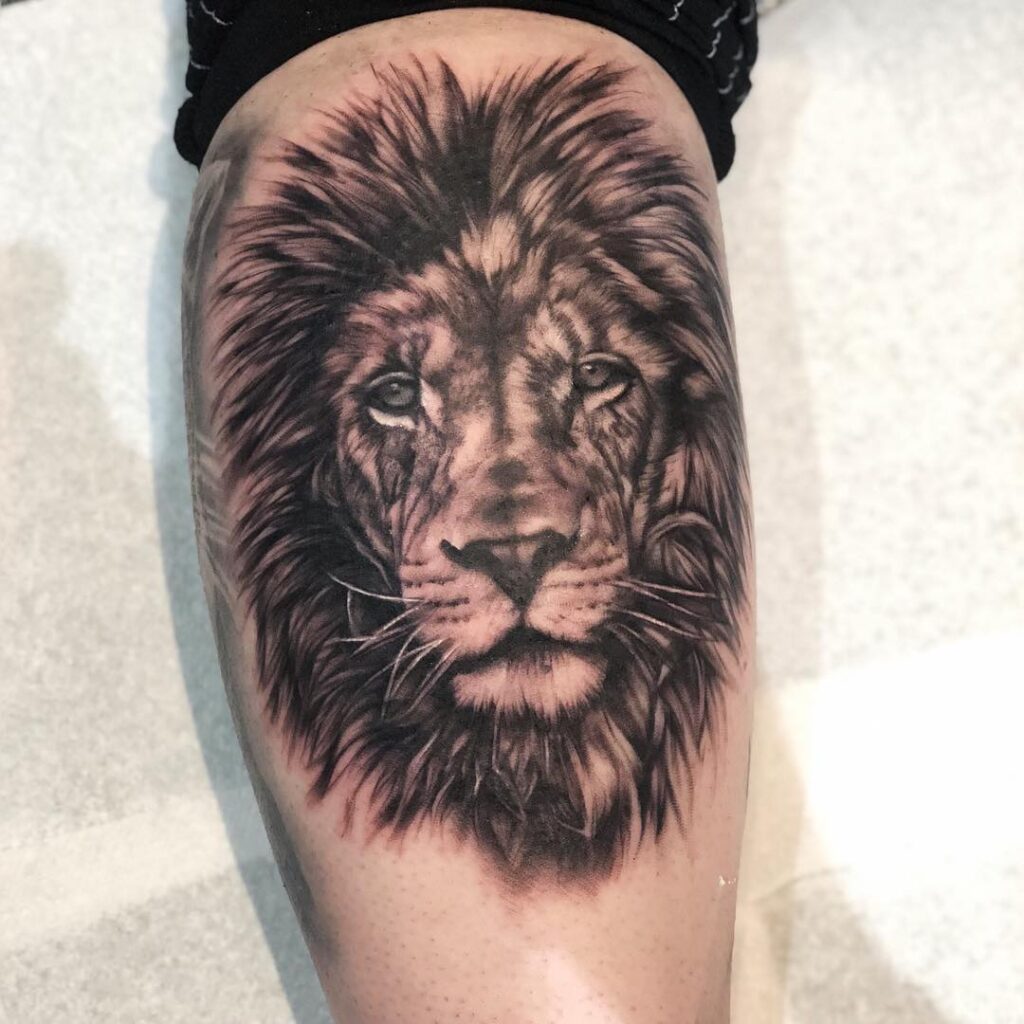 Black Work Lion Head Tattoo, a Majestic Statement on the Calf: Lion's Gaze 