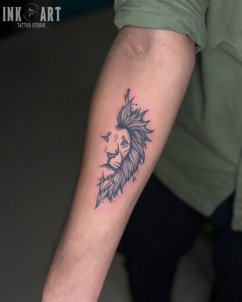 Blackwork ink half lion head tattoo on the forearm, intensified by striking red eyes crimson gaze