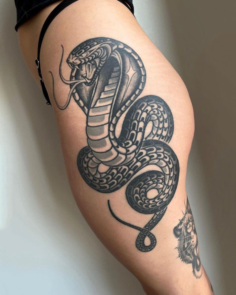Blackwork stunning angry king cobra tattoo on the side thigh heavy-duty ink