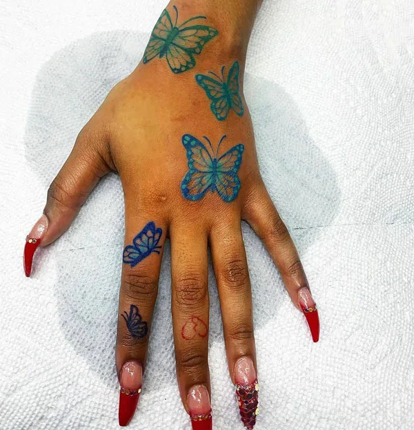 Blue butterfly hand tattoo