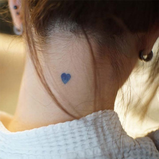Blue heart tattoo on neck