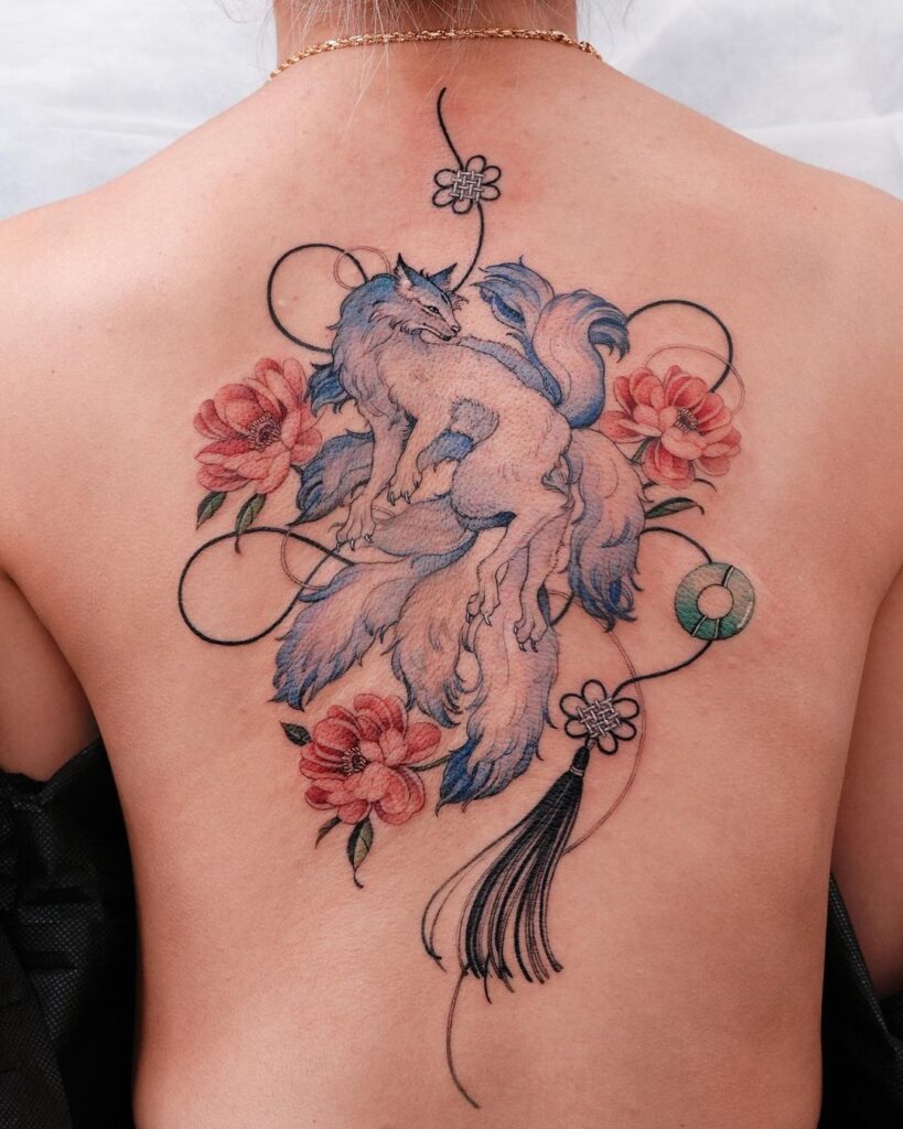 Blue ninetailed fox and red peony back tattoo a striking composition