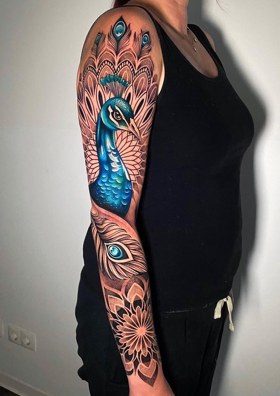 Blue peacock feather tattoo for hand with mandala art Blue peacock feather tattoo for hand with mandala art