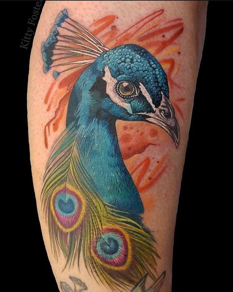 Blue peacock feather tattoo on hand with elaborate design Blue peacock feather tattoo on hand with elaborate design
