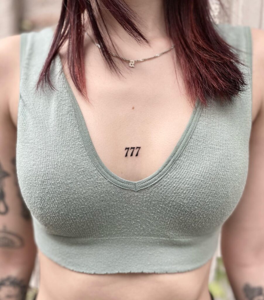 Bold 777 Number Tattoo on the Middle Chest for Females: Heavenly Charm 