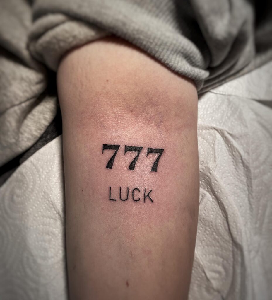 Bold 777 number with "luck" lettering a striking and meaningful tattoo lucky forearm tale 