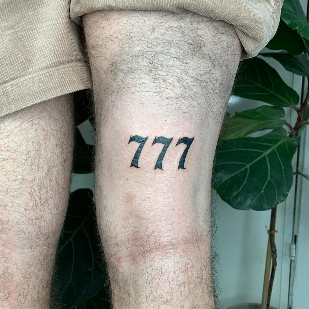 Statement with Bold 777 Tattoo Behind the Knee: Knee Luck 
