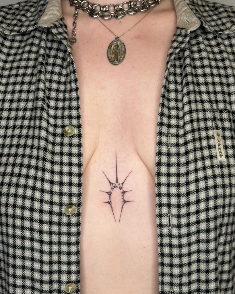 Bold abstract sternum tattoo with geometric and skeletal-inspired design