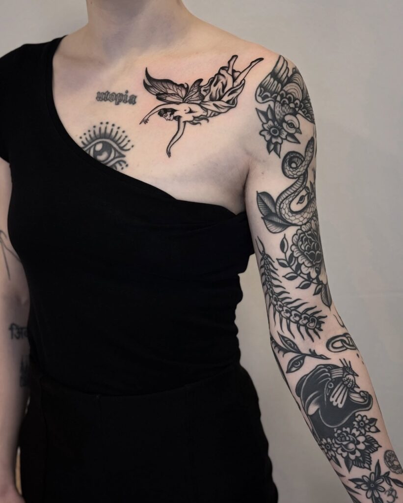 Bold black ink tattoo collection with fairy, snake, and panther