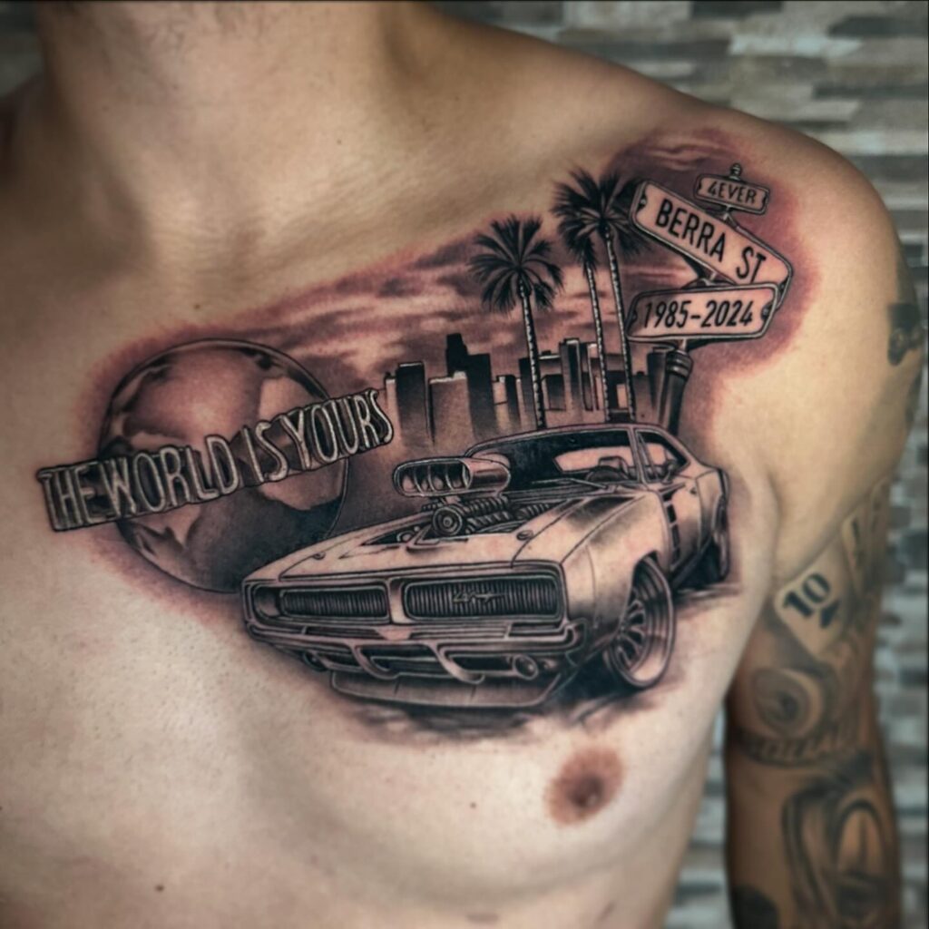 Bold Classic Muscle Car Tattoo with Supercharger, City Skyline & "The World Is Yours" on Chest – Car Tattoo Ideas