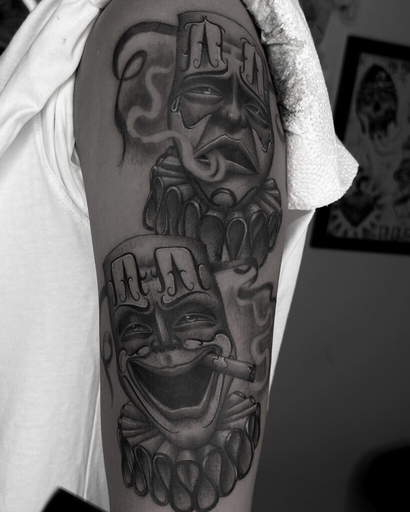 Bold half sleeve laugh now cry later on the upper arm 
