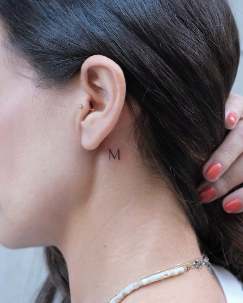 Bold M Letter Tattoo Behind Ear Striking Yet Understated Initial Design