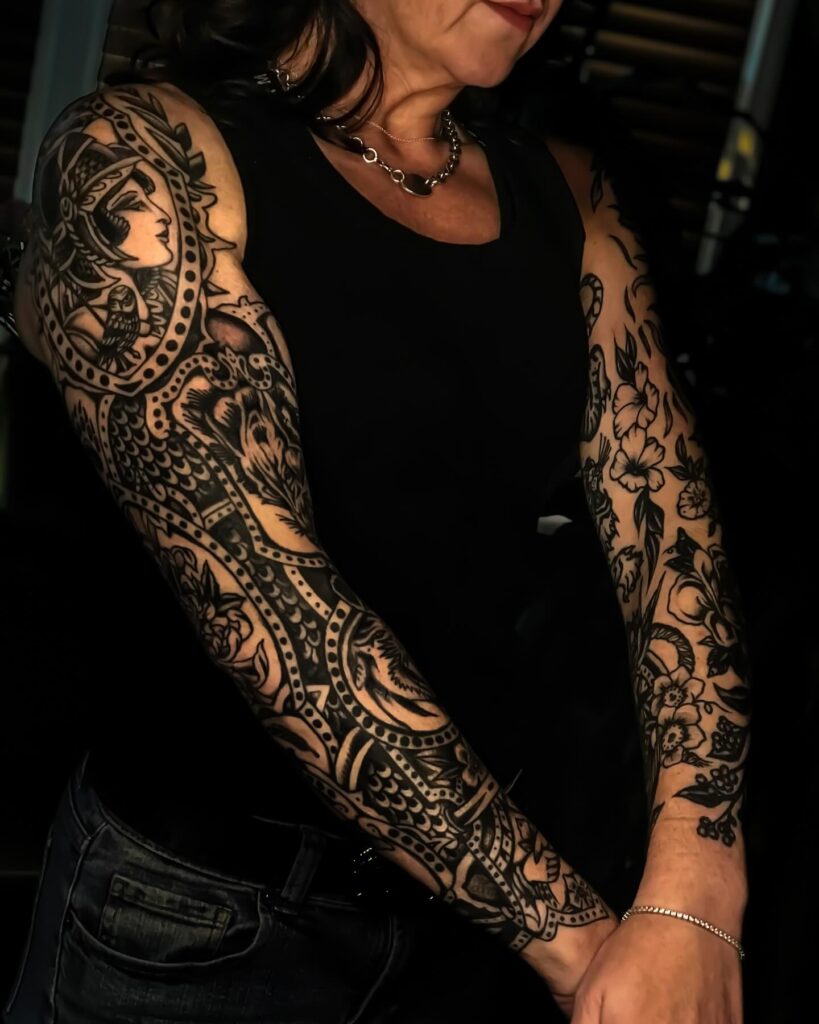 Bold ornamental warrior woman tattoo sleeve with geometric detailing