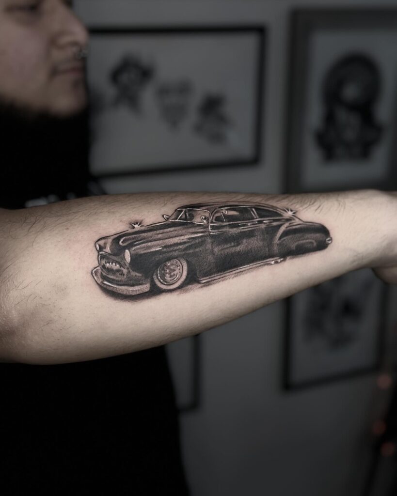 Bold Realistic Classic Car Tattoo with Shading on Outer Forearm – Car Tattoo Ideas