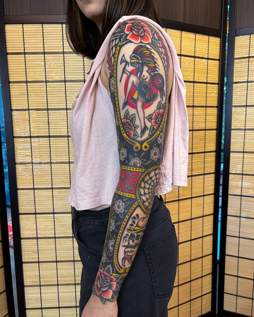 Bold Traditional Full-Sleeve Tattoo with Warrior and Skull Motifs