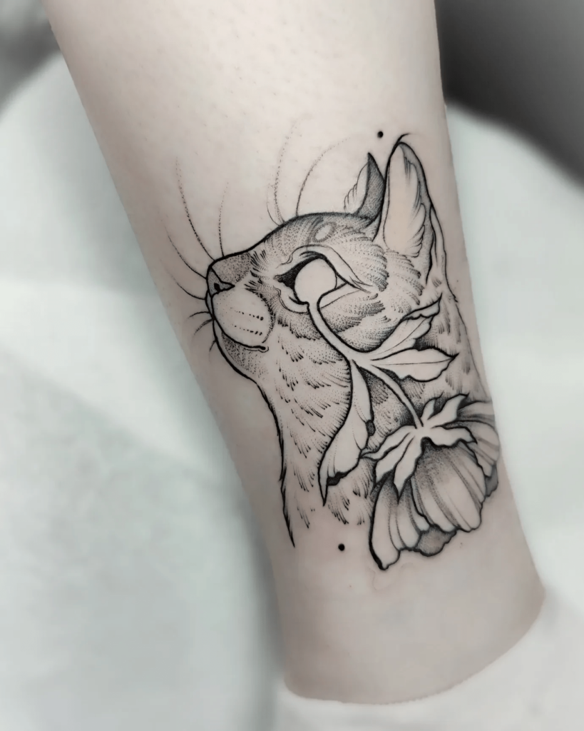 Botanical side-profile cat tattoo with floral elements