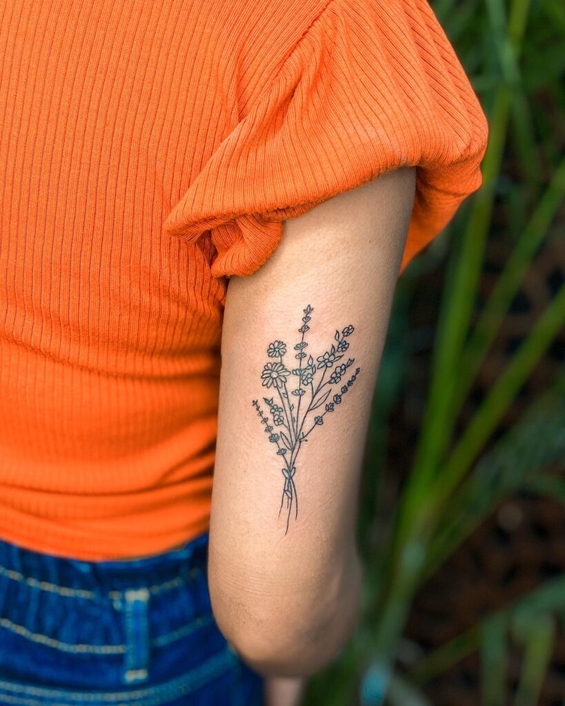 Bunch of flowers tattoo back of the arm